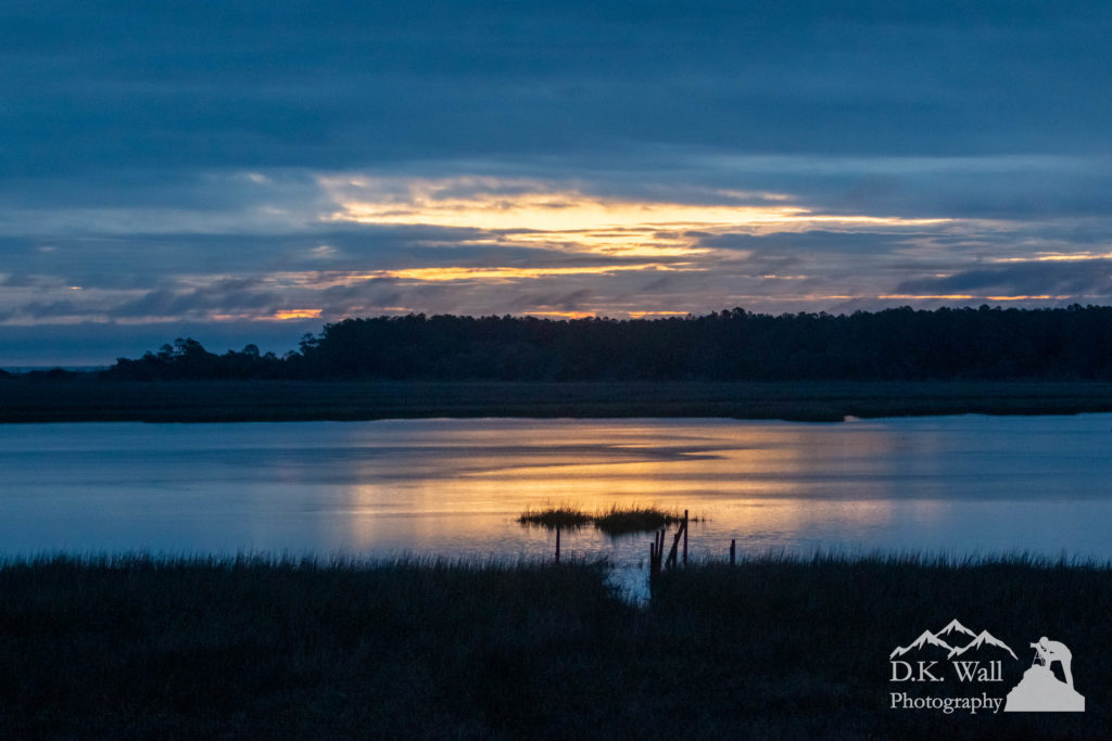 The rains stopped and the morning clouds broke up over the ocean, letting just a hint of sunrise glisten on the marsh.