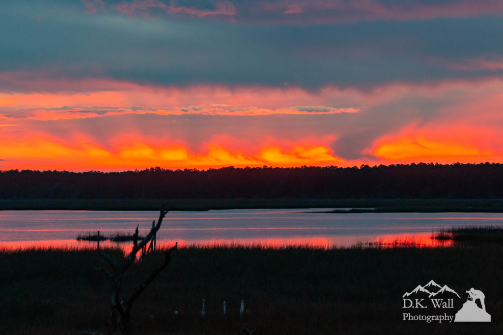 Glowing sunrise over the salt marsh on a stormy morning.